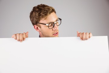 Poster - Geeky hipster showing a card