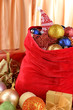 Red bag with Christmas toys on fabric background