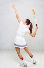Beautiful Girl In Tennis Clothes, Brandishing A Tennis Racket On