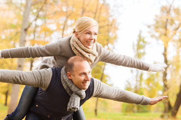 Poster - smiling couple having fun in autumn park