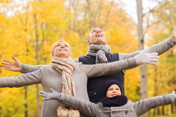 Canvas Print - happy family having fun in autumn park