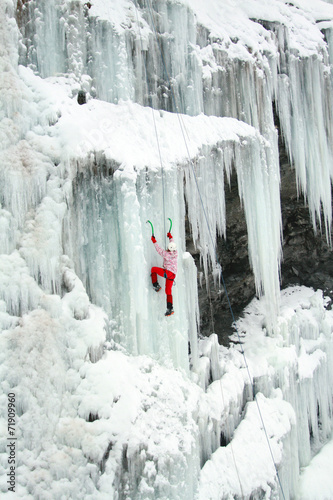 Naklejka ścienna Ice climbing the waterfall.