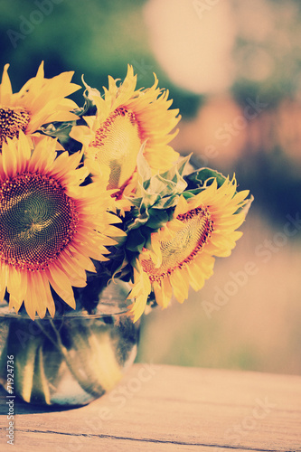 Naklejka na szybę Beautiful sunflowers on table on bright background