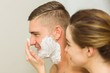 © WavebreakMediaMicro - Woman putting shaving foam on boyfriends face