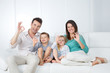 © Dave_Pot - positive family sitting on sofa