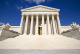 Fototapeta  - Supreme courthouse in Washington, blue sky behind.