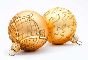 Two golden christmas balls isolated