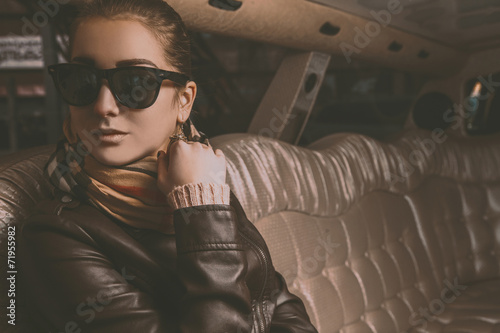 Photographie Young adult brunette girl looking away in limousine