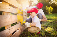 Father And Son Painting Fence