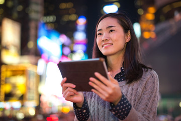 Sticker - Young Asian Woman using tablet pc at night