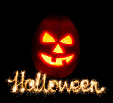 Halloween pumpkin jack-o-lantern candle lit and the inscription