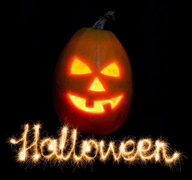 Halloween pumpkin jack-o-lantern candle lit and the inscription