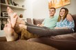 © WavebreakMediaMicro - Cute couple relaxing on couch