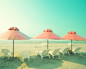 Sticker - Vintage pink umbrellas in summer beach