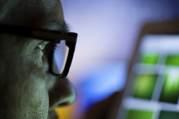 Man With Glasses Using Tablet Computer