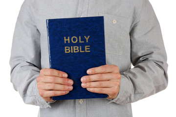 Wall Mural - Man holding Bible isolated on white