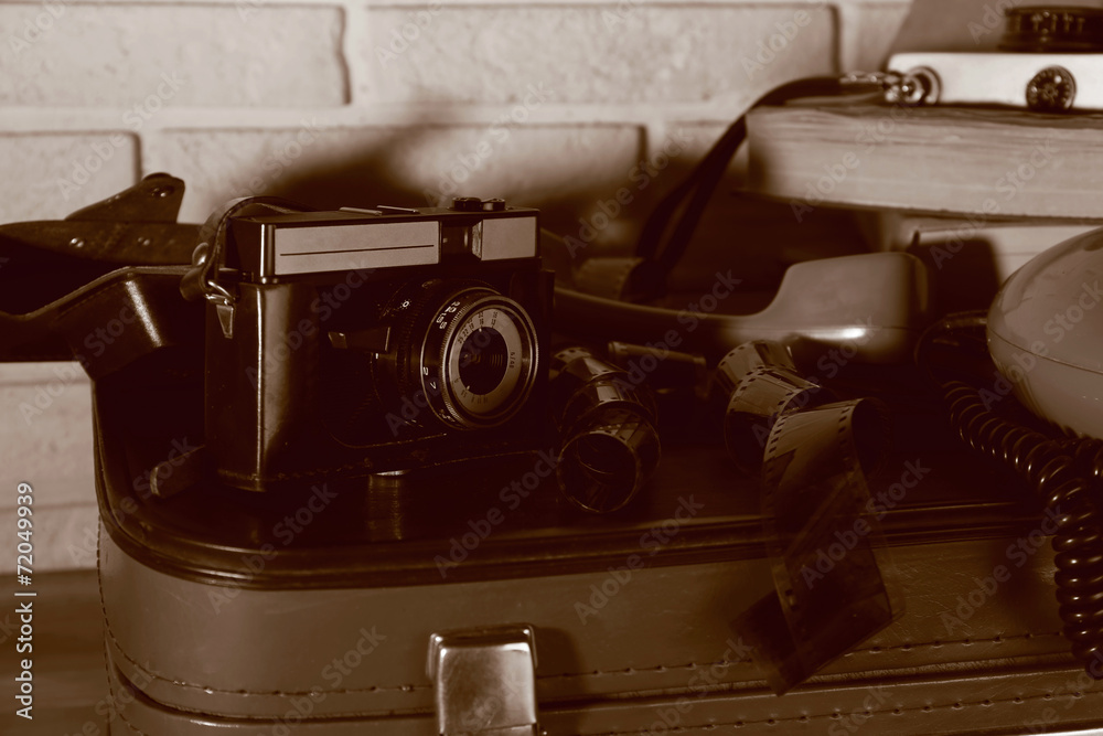 Old travel suitcases with retro things, close up