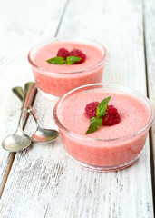 Wall Mural - Delicious berry mousse in bowls on table close-up