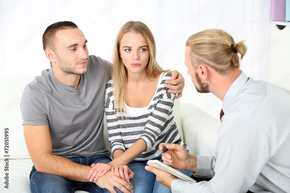 Young couple with problem on reception for family psychologist