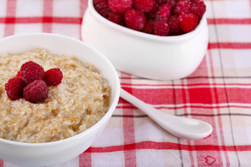 Wall Mural - Tasty oatmeal with berries on napkin close-up