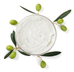 Wall Mural - cosmetic cream in container and olives with leaves, top view