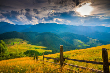 Wall Mural - amazing mountain landscape with fog and a haystack