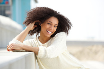 Wall Mural - Beautiful young african american woman smiling outdoors