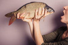 Silly Young Woman Posing With A Carp