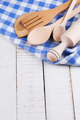 Canvas Print - Wooden spoons, roller on towel on table.