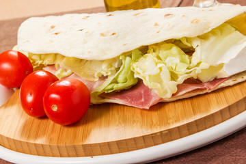 tasty flatbread with ham and mozzarella cheese