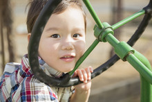 Mixed Race Young Boy Playing On Tractor