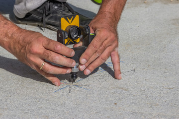 Total station prism with survey worker hands 2