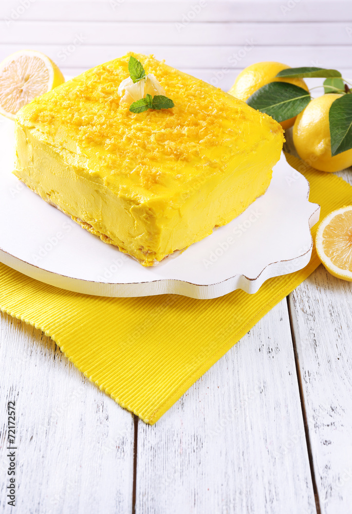 Tasty lemon cake on wooden table