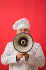 Wall Mural - Portrait of caucasian man with chef uniform holding megaphone