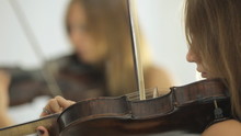 Beautiful Girl Playing The Violin In Front Of Her Mirror's