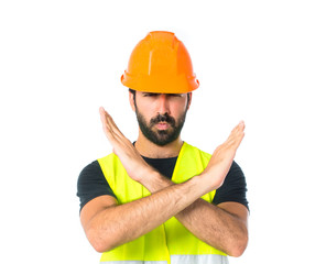 Wall Mural - Workman making stop sign over white background