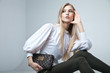 © julenochek - Fashionable woman with a bag in light background
