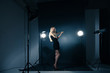 © julenochek - Beautiful woman posing at studio in light flashes