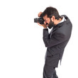 © luismolinero - Businessman photographing over white background