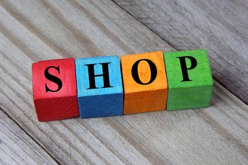 Wall Mural - concept of shop word on wooden colorful cubes