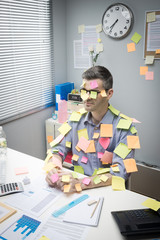 Wall Mural - Office worker covered with stick notes