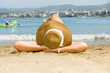 Woman in a hat lying on the sandy beach