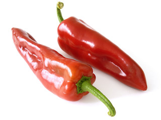 two red sweet peppers on white