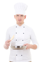 Wall Mural - young man chef in uniform holding frying pan isolated on white