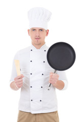 Wall Mural - young handsome man chef in uniform with frying pan isolated on w