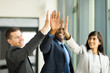 © michaeljung - business team giving high five