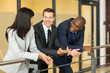 © michaeljung - businessman having conversation with colleagues