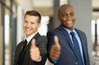 © michaeljung - multiracial business men thumbs up