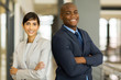 © michaeljung - corporate colleagues with arms crossed in office