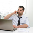 © Studio Gi - Businessman with laptop talking on the phone
